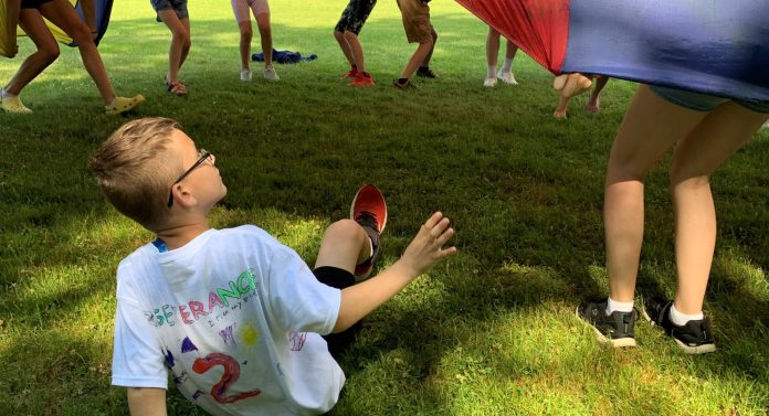 Second Grader Observes the Fun From the Ground on Field Day