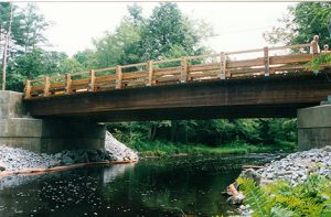 The soon-to-be-dedicated Lee Murray Bridge on Lyndeborough Road in New Boston. Lee, the New Boston road agent at the time, convinced the New Boston selectmen to let his crew to erect the wooden bridge. The July 2000 project was a great success and was completed a month early.