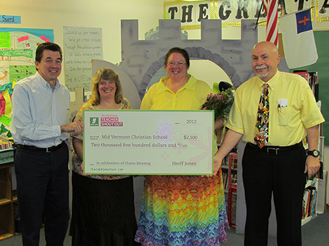 Cheri Blessing (second from right) poses with half of the $5,000 award for inspired teaching presented to her and to Mid Vermont Christian School, where she teaches. The award was from the Herff Jones company, a manufacturer of school achievement and celebration products and an educational publisher.