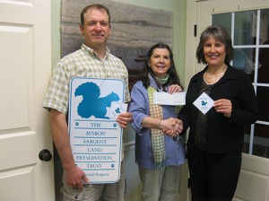 Karen Zurheide (right) of Ledyard National Bank presents Ausbon Sargent Executive Director Debbie Stanley with a check for $1,000. Ledyard’s generous donation will allow Ausbon Sargent to purchase easement signs and boundary markers for their protected properties, like the ones held by Karen and Ausbon Sargent’s Stewardship Manager Andy Deegan. These markers share the good work and combined efforts of the Ausbon Sargent Land Preservation Trust (ASLPT) and the land owners with those passing through the 12 communities (including Andover) represented by ASLPT. Photo: Peggy Hutter