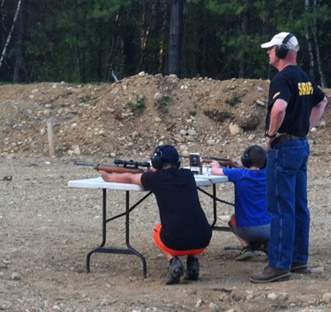Deputy Sheriff Bruce Clough supervises Boy Scouts Jared Frost and Matt Bent at the Merrimack Sheriff's Shooting Range.