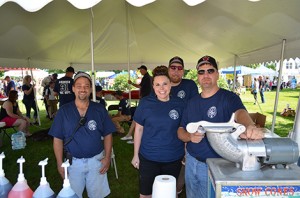 Andy Guptill, Tiffany Garon, AJ Barton, and Steve Barton, all volunteers from the Andover Fire Department, worked hard on the Fourth of July selling sno-cones. The high temperatures helped in the fundraising efforts of the Andover Fire Department. Photo and caption: Meghan Barton.