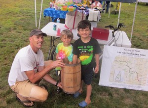 Peter Southworth held the nail key while Isaac and Elliott Norris picked the winning raffle names for the FNRT raffle at the Andover Historical Society's Old Time Fair at Potter Place on August 4.