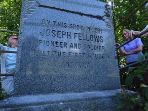 The monument erected about 100 years ago to Andover settler Joseph Fellows. On the reverse it reads: "Here Joseph and Margaret (Webster) Fellows founded the first home in Andover." On the left is Susan Chase; on the right is Pam Cooper. Photo: Larry Chase