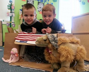 Aidan and Liam Duchesne are excited to open a package for Imagination Inn that arrived from their dad, Brian who is serving in Afghanistan. Photo: Doreen Perreault