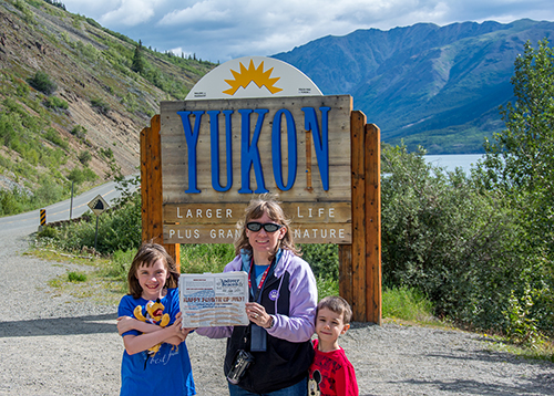 Joel, Tiffany, Sierra, and Cody Provost enjoyed a Disney cruise to Alaska in July ... with their copy of the Beacon. Pictured are Sierra, Tiffany, and Cody during the family's drive from Skagway, Alaska to the Yukon Territory of Canada. Photo: Joel Provost