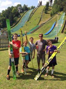 Andover Outing Club members Alex Burt, Sophia Reynolds, Matthew Reynolds, and David Reynolds (right) were excited to learn that Chris Lamb (second from right) would be coaching them at ski-jumping camp in Lake Placid. Photo: Christina Scherer