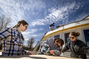 Students at work on Colby-Sawyer's new free-standing, sustainable classroom -- built of straw bales.