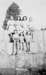 The bridge abutment on our side of the brook, which was used for the second path that Route 11 took. The abutment is still there today. This picture was taken in 1944; I'm the unhappy little one in the first row. Our backs are towards our house, and you can see the maple tree that is still there today. Caption by Rita Norander