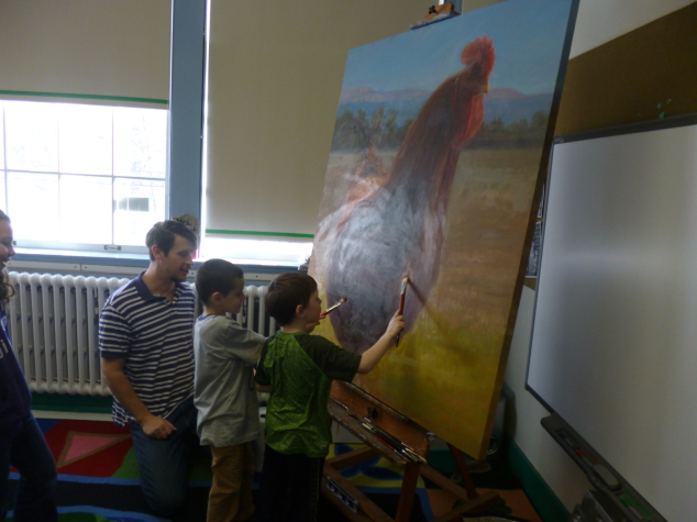 On January 28, local artist J. Koron, (dad to AE/MS student Victoria Koron) came to visit the AE/MS first graders. He talked about the different kinds of tools he uses when he paints (including a paintbrush made from badger hair) and about his life as an artist. The children were in awe of a canvas painted with a rooster that is bigger than they are! Each child (including Jacob Hersey and Sam Gilman, pictured here) added a few strokes of their own to his work. J. also encouraged the students to work hard, because they can become anything they want ... a message supporting the class' current study of "The Power of One," which is about how one person can make a difference in the world. Photo: Jen Bent