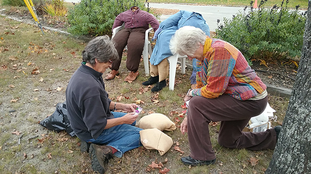 Town Librarian and a Volunteer Create Scarecrows