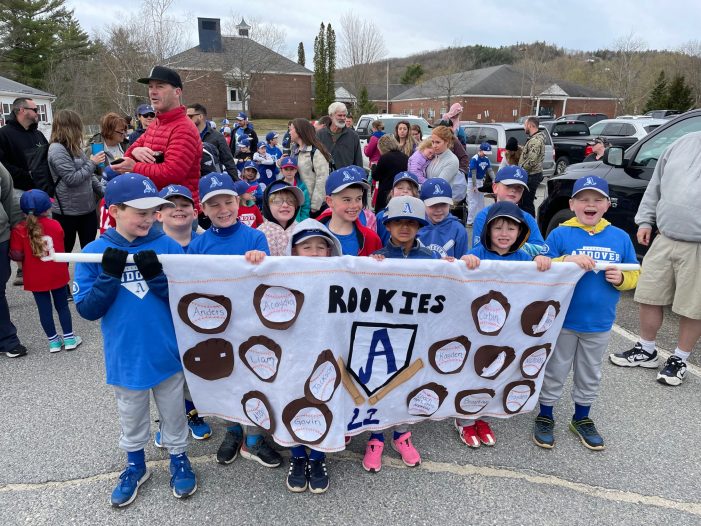 The Rookies Team Proudly Stands with Their Banner on Opening Day