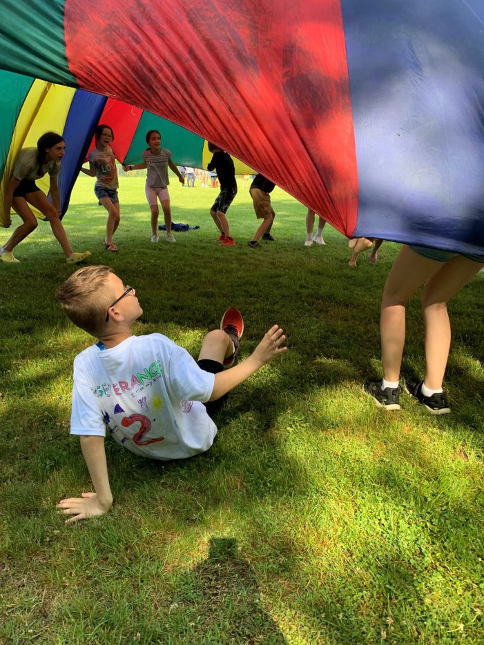 Second Grader Observes the Fun From the Ground on Field Day