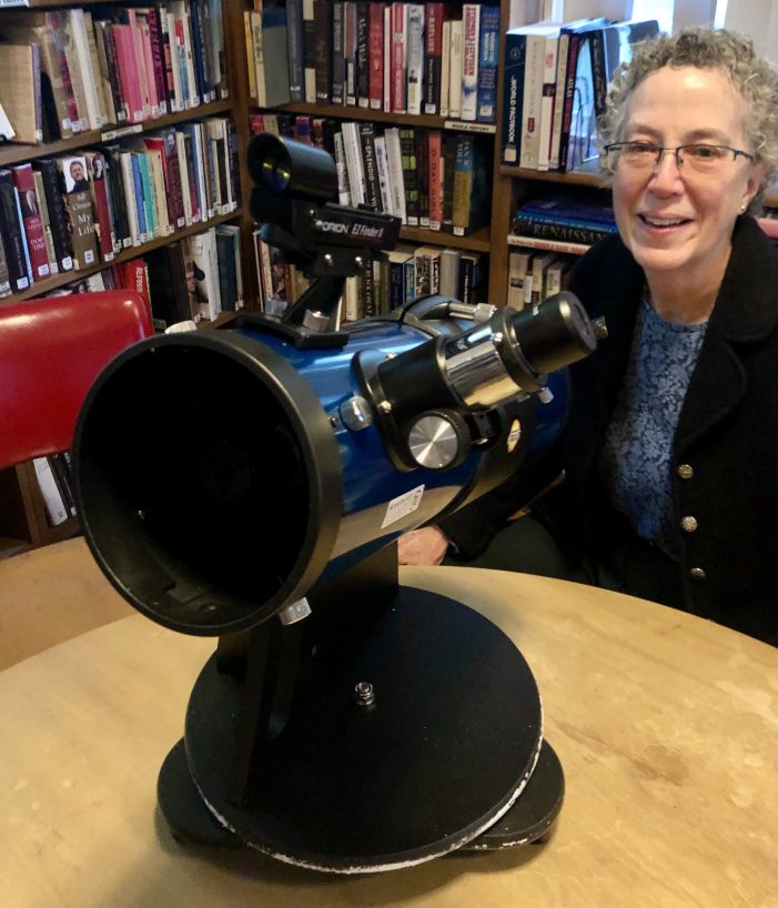 Bachelder Librarian Admires the Newly Donated Orion Starblast Telescope